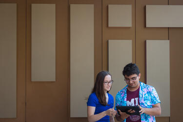 Two students in front of the MIT Welcome Center